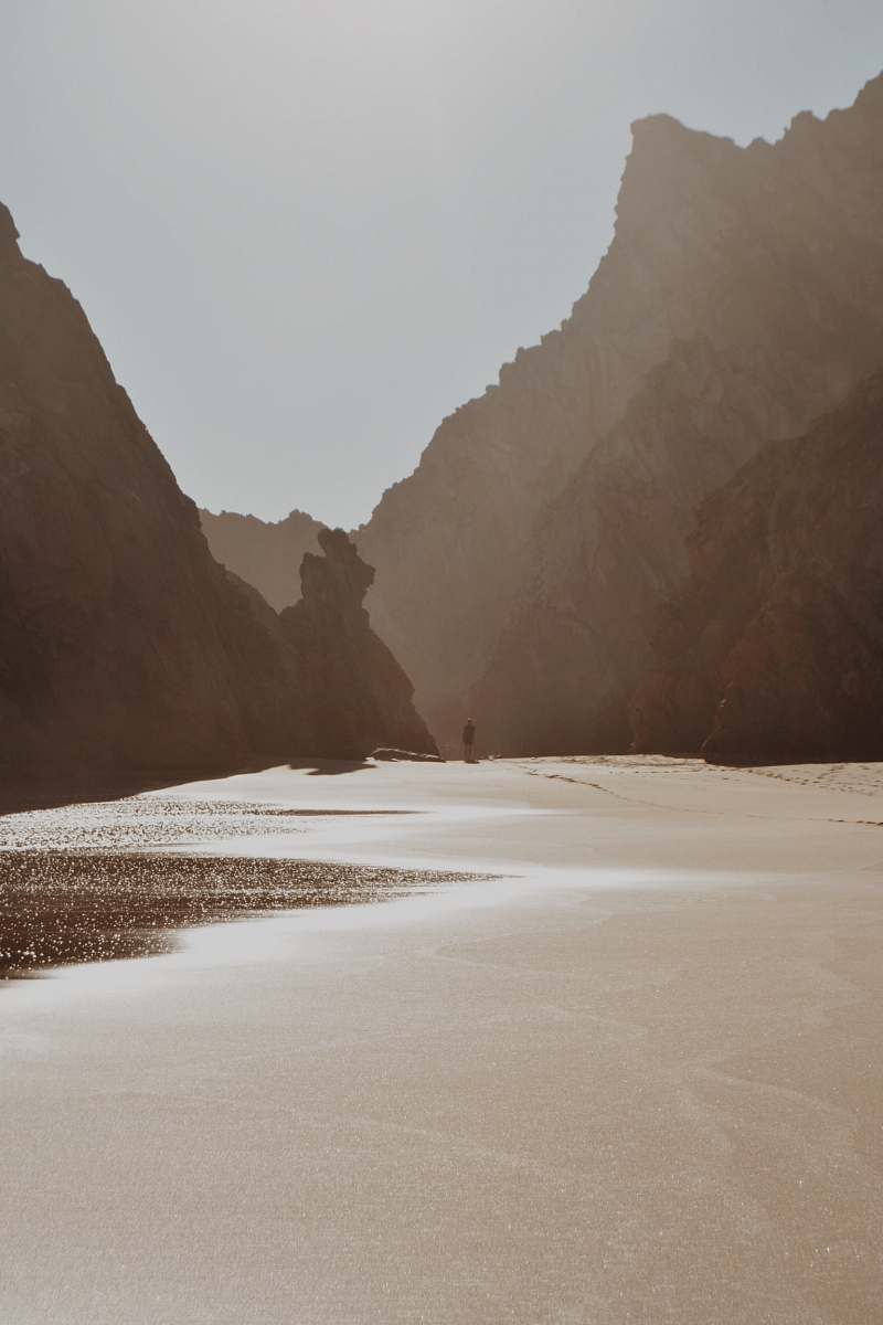 portugal man walking near shore beach